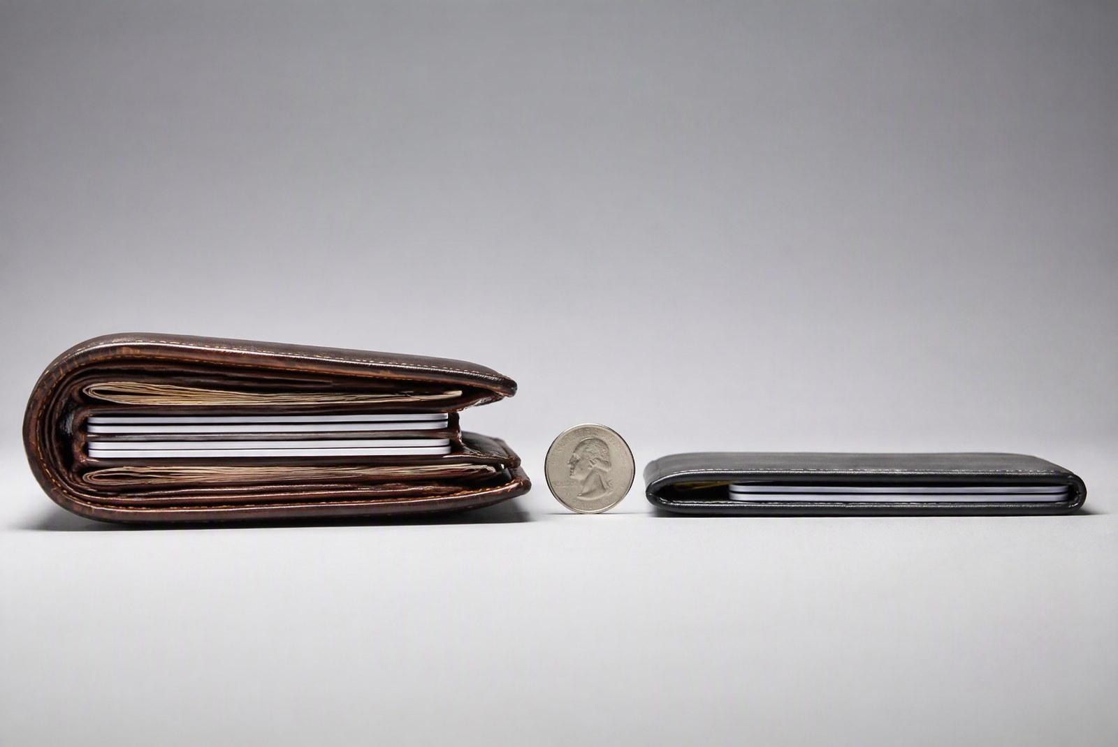 comparison: macro studio shot comparing wallet thicknesses side by side with a credit card for scale, product photography