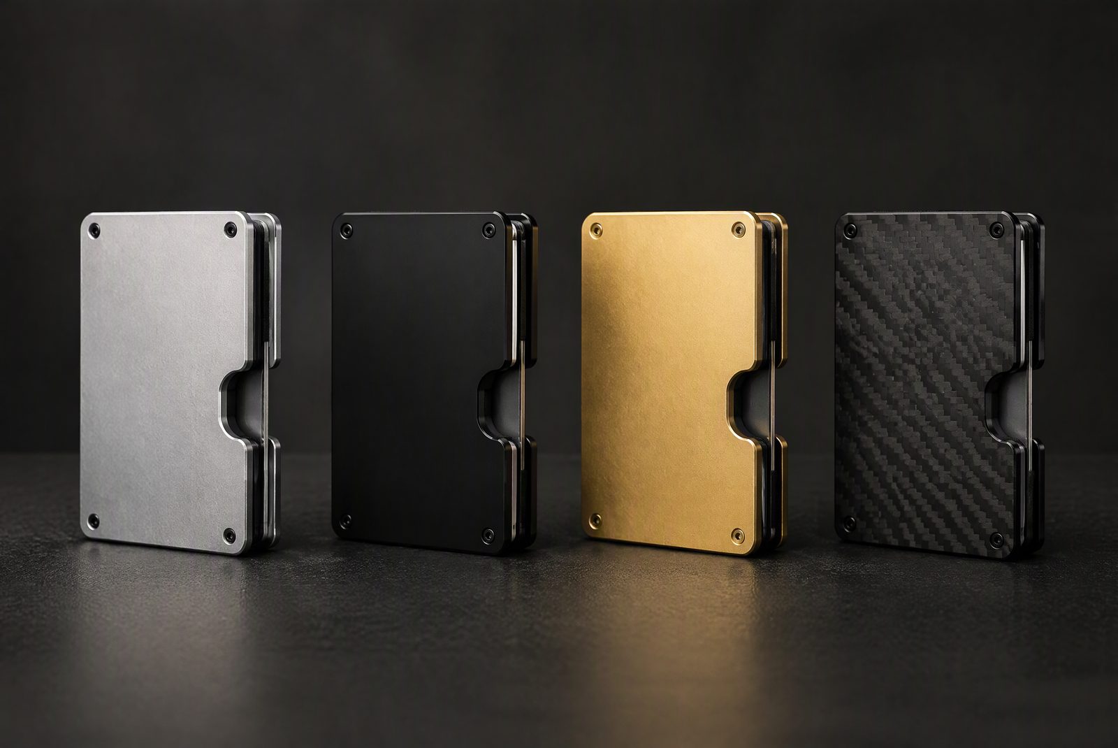 A lineup of aluminum ridge-style wallets in different finishes on a dark surface