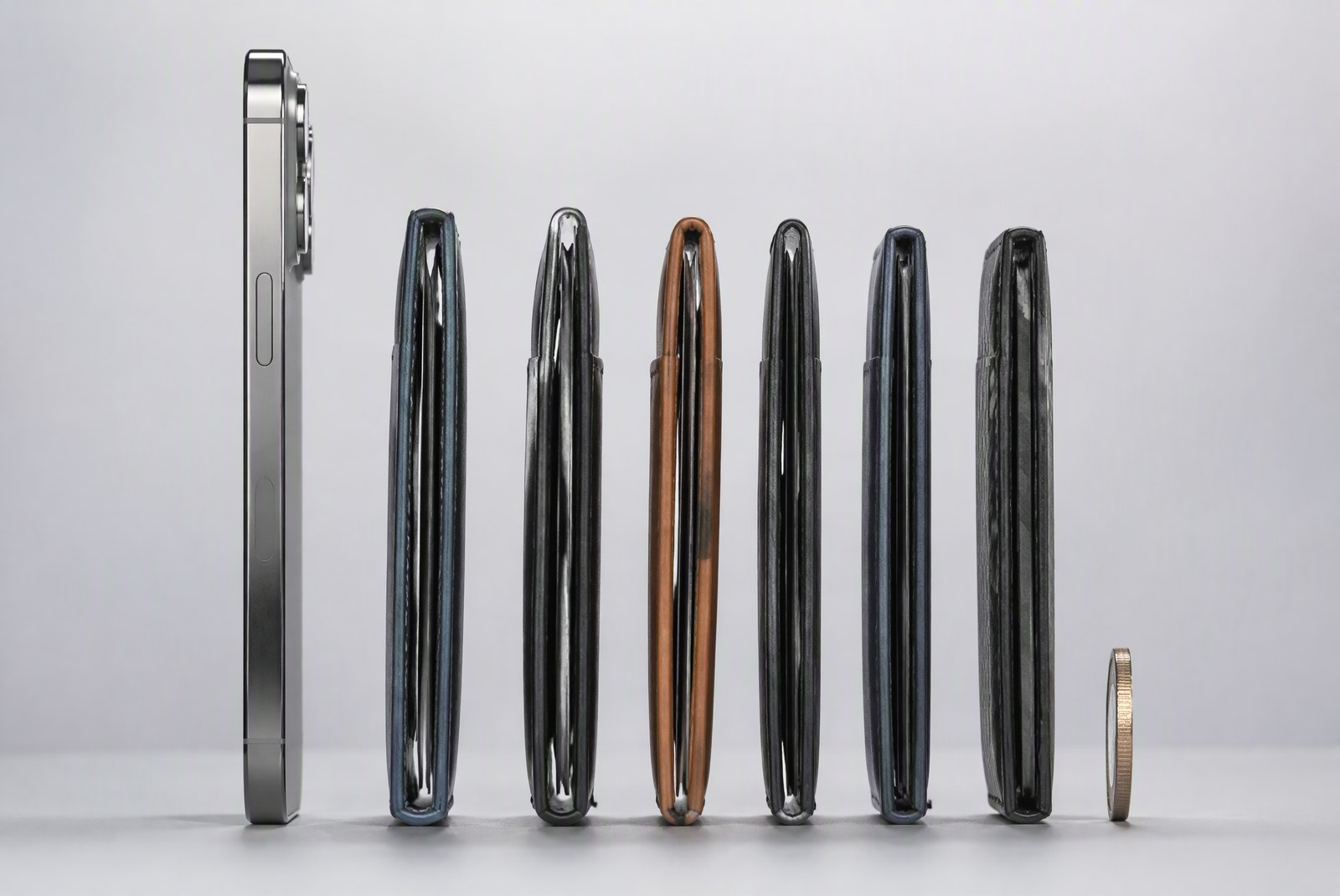 comparison: three-wallet thickness comparison profile shot showing the Ridge aluminum, a leather slot wallet, and a card stack measured against the ruler's 10-millimetre mark