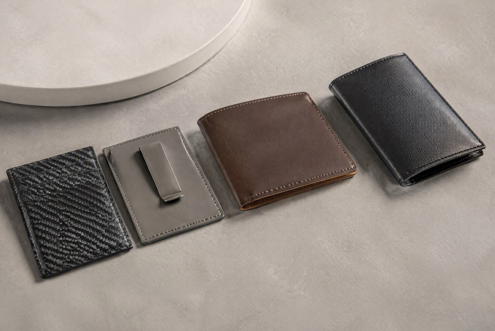 types: side-by-side close-ups of the three construction types in this list: two-plate elastic cardholder, button ejector wallet, and magnetic two-plate card case