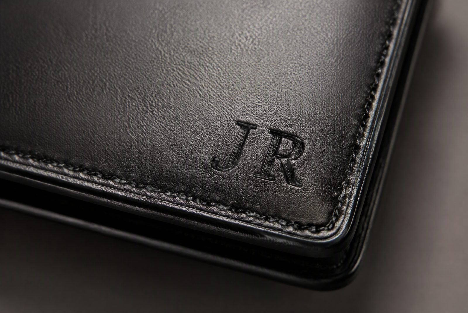 Common engraving placements: exterior leather, interior leather, above card slot, and metal plate