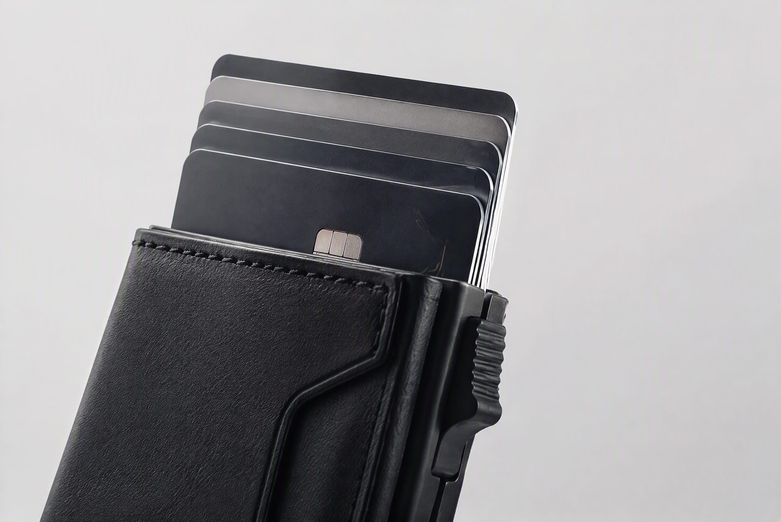 Three pop-up wallets side by side: cam design, pull-tab design, and an OEM sample