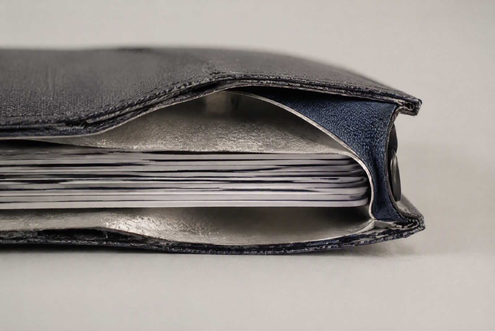RFID shielding layer wrapping the entire card stack inside the wallet cavity