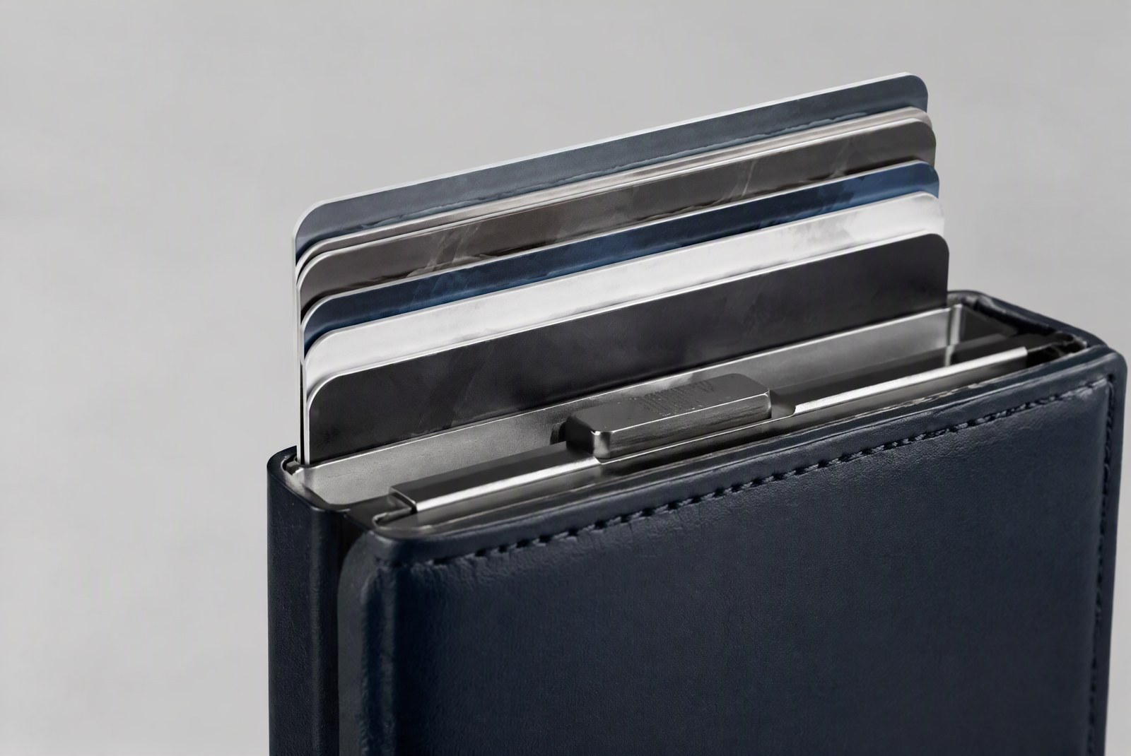 feature: Manufacturing shot of aluminum cardholder cases lined up on a quality-control inspection tray at the TOPWALLET factory