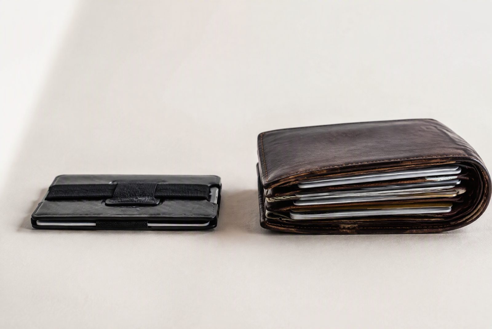 Mechanism close-up: a pop-up wallet slider mid-throw with cards fanning out