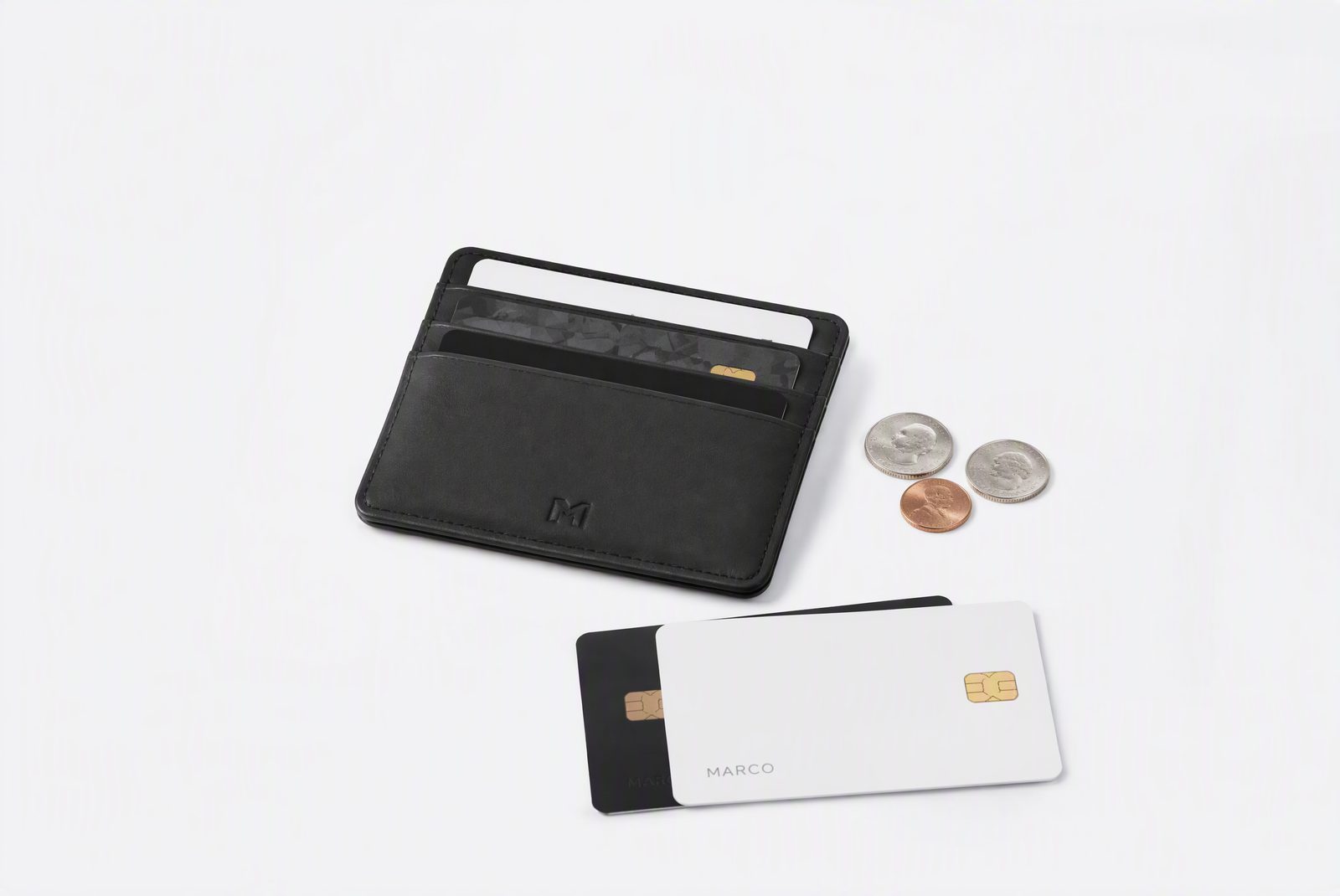 A slim card case next to a phone and keys on a minimal desk, showing the pocket-profile contrast